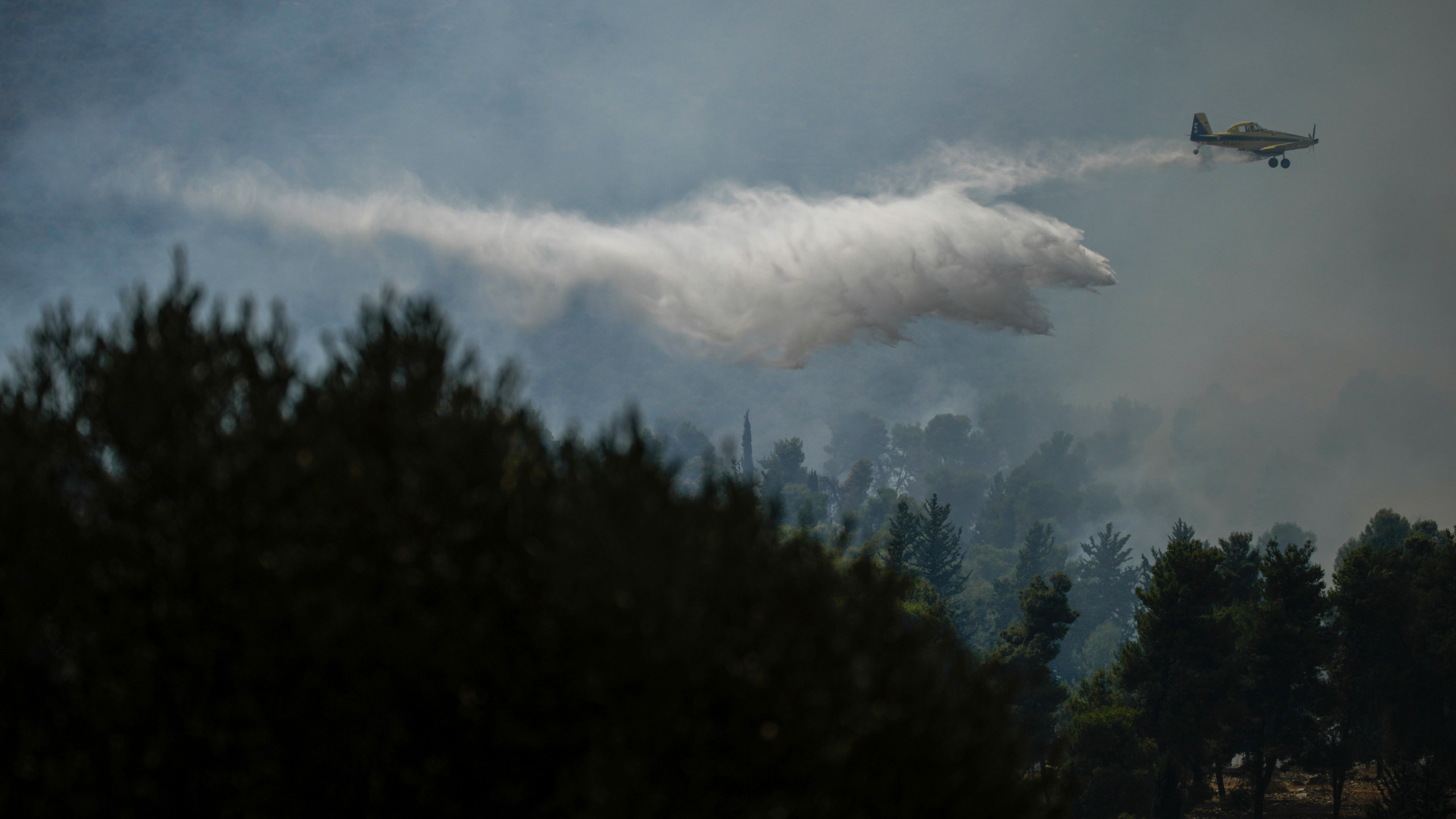 An Israeli firefighters plane uses a fire retardant to extinguish a fire after a rocket fired from Lebanon hit an open area near the city of Safed, northern Israel, on Wednesday, Sept. 25, 2024. (AP Photo/Leo Correa)