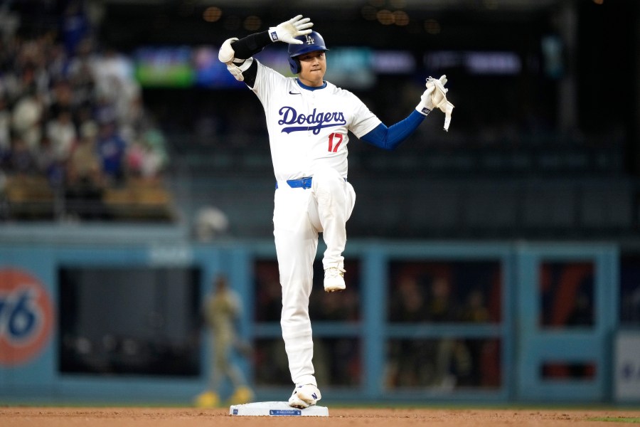 Los Angeles Dodgers' Shohei Ohtani gestures toward his dugout after hitting a double during the first inning of a baseball game against the San Diego Padres, Tuesday, Sept. 24, 2024, in Los Angeles. (AP Photo/Mark J. Terrill)