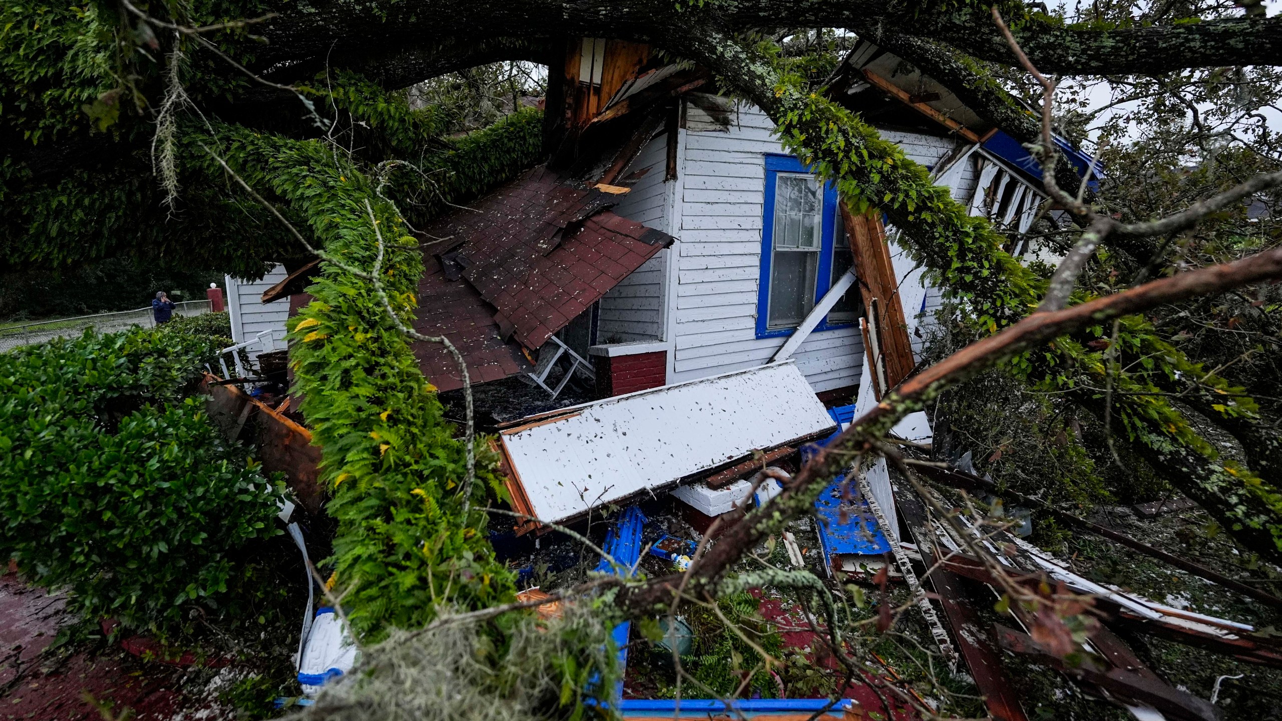 A damaged 100-year-old home is seen after an Oak tree landed on it after Hurricane Helene moved through the area, Friday, Sept. 27, 2024, in Valdosta, Ga. (AP Photo/Mike Stewart)