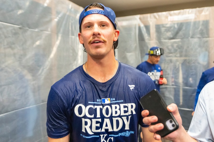 Kansas City Royals shortstop Bobby Witt Jr. speaks with a reporter during a celebration in the locker room after a baseball game against the Atlanta Braves, Friday, Sept. 27, 2024, in Atlanta. (AP Photo/Jason Allen)