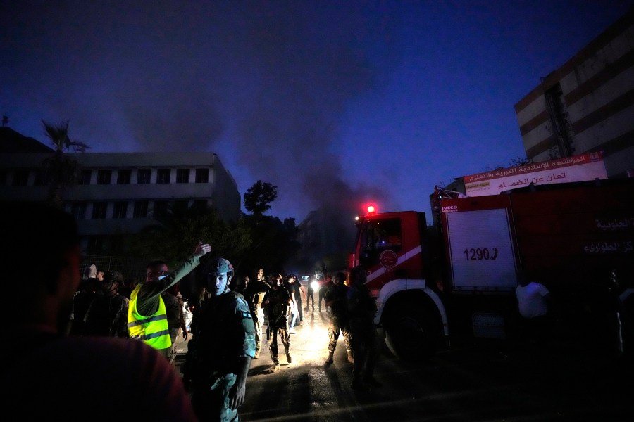 Rescuers arrive near the site of an Israeli airstrike in Beirut's southern suburbs, Friday, Sept. 27, 2024. (AP Photo/Hassan Ammar)