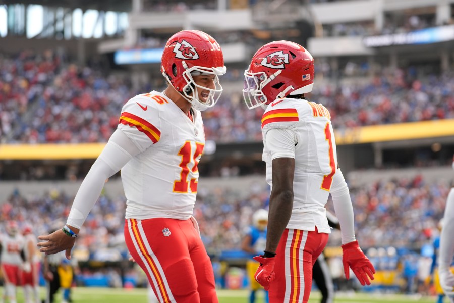 Kansas City Chiefs wide receiver Xavier Worthy, right, is celebrates after catching a 54-yard touchdown pass from teammate Patrick Mahomes, left, during the first half of an NFL football game against the Los Angeles Chargers Sunday, Sept. 29, 2024, in Inglewood, Calif. (AP Photo/Ashley Landis)