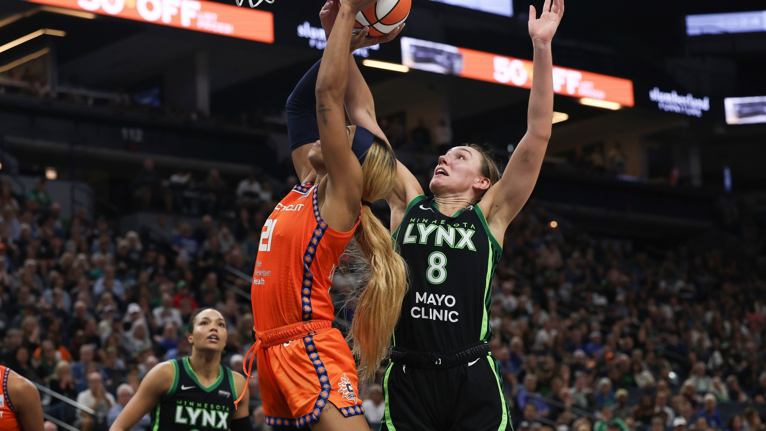 Minnesota Lynx forward Alanna Smith (8) blocks a shot by Connecticut Sun guard DiJonai Carrington (21) during the second half of Game 1 of a WNBA basketball semifinals series Sunday, Sept. 29, 2024, in Minneapolis. (AP Photo/Stacy Bengs)