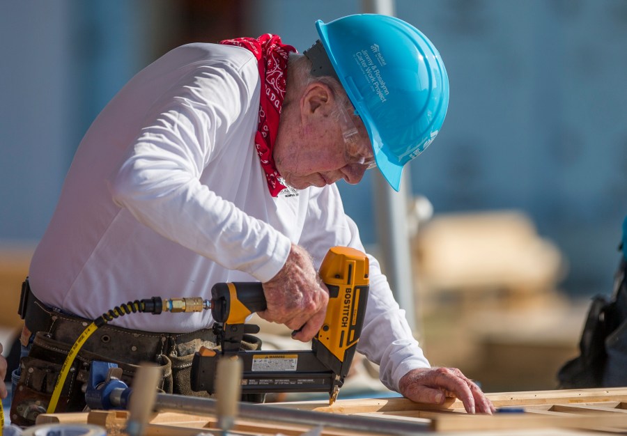 FILE- In this Aug. 27, 2018 file photo, former President Jimmy Carter works with other volunteers on site during the first day of the weeklong Jimmy & Rosalynn Carter Work Project, their 35th work project with Habitat for Humanity, in Mishawaka, Ind. Carter turns 95 on Tuesday, Oct. 1, 2019. (Robert Franklin/South Bend Tribune via AP, File)