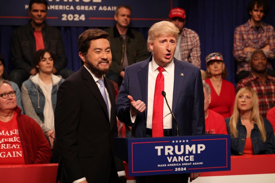 This image released by NBC shows Bowen Yang as JD Vance, left, and James Austin Johnson as Donald Trump, during the cold open sketch on "Saturday Night Live" in New York on Saturday, Sept. 28, 2024. (Will Heath/NBC via AP)