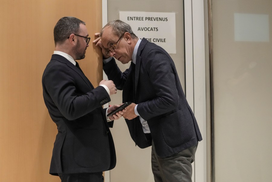 Member of the French far right party Alexandre Varaut, left, talks to an unidentified person at the court house in Paris, Monday, Sept. 30, 2024. (AP Photo/Thibault Camus)