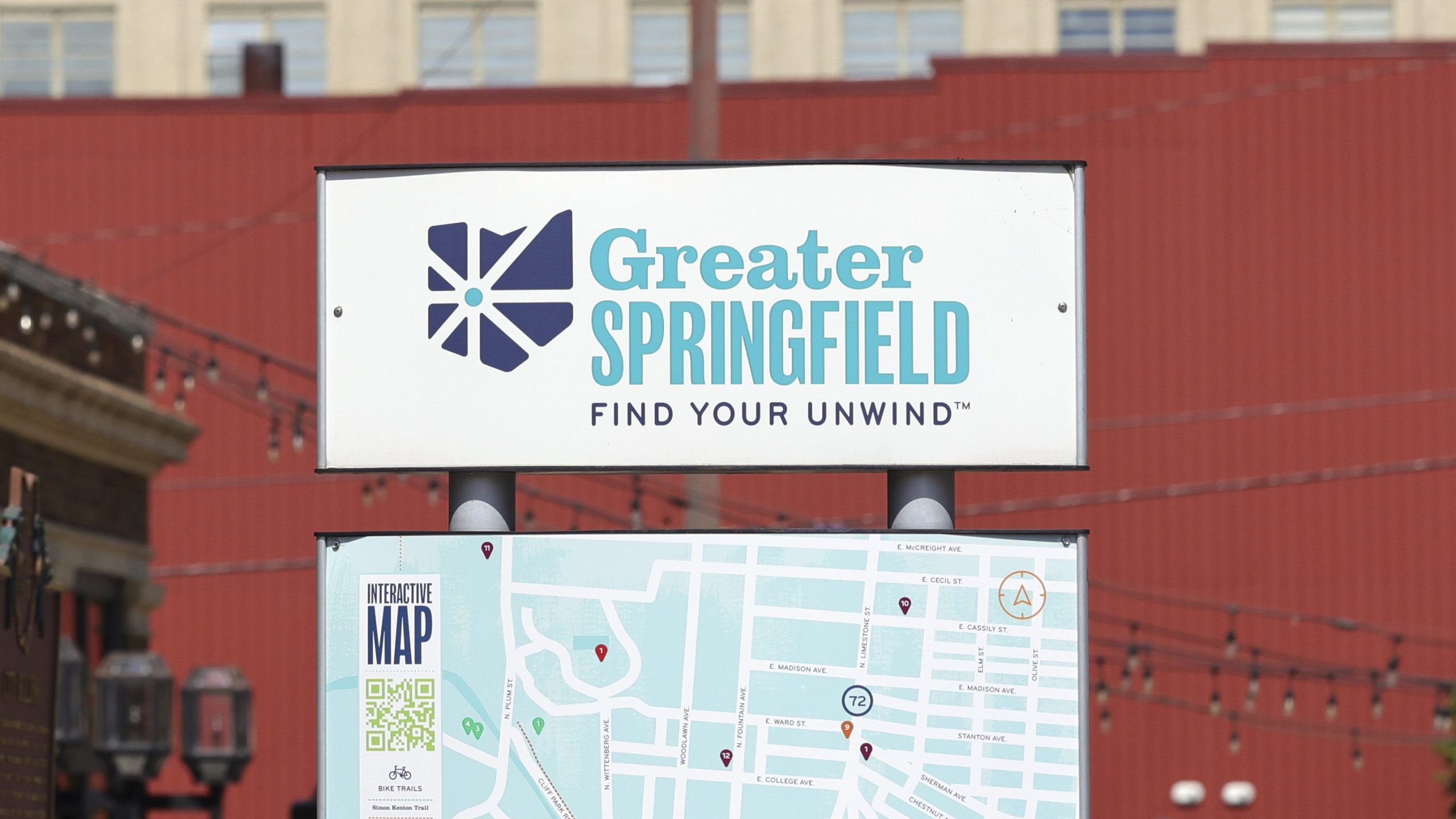 A sign that says Greater Springfield Find Your Unwind and a map of downtown is showing.