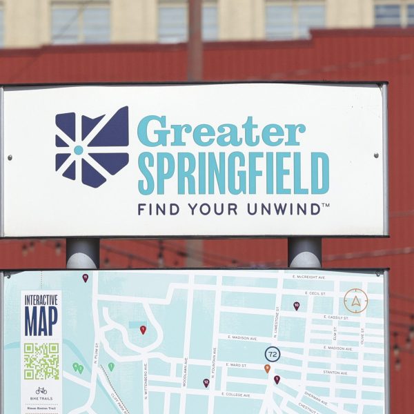 A sign that says Greater Springfield Find Your Unwind and a map of downtown is showing.