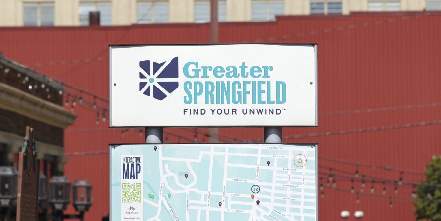 A sign that says Greater Springfield Find Your Unwind and a map of downtown is showing.