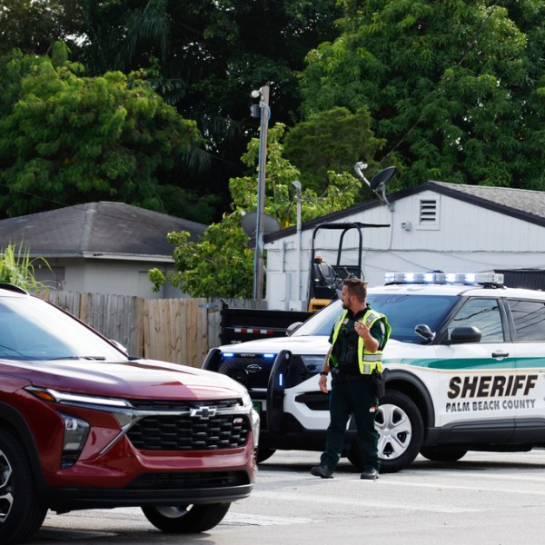 A police officer directs traffic near Trump International Golf Club after the apparent assassination attempt of Donald Trump on Sept. 15, 2024.