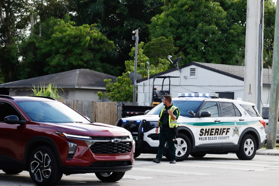 A police officer directs traffic near Trump International Golf Club after the apparent assassination attempt of Donald Trump on Sept. 15, 2024.