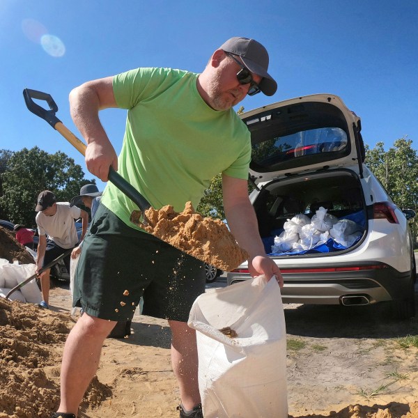 Justin Fogle, of College Parks, fills a sandbag at the Orange County distribution site at Barnett Park in Orlando, Fla., Tuesday, Sept. 24, 2024, ahead of the forecast for the possibility of heavy rains in Central Florida.