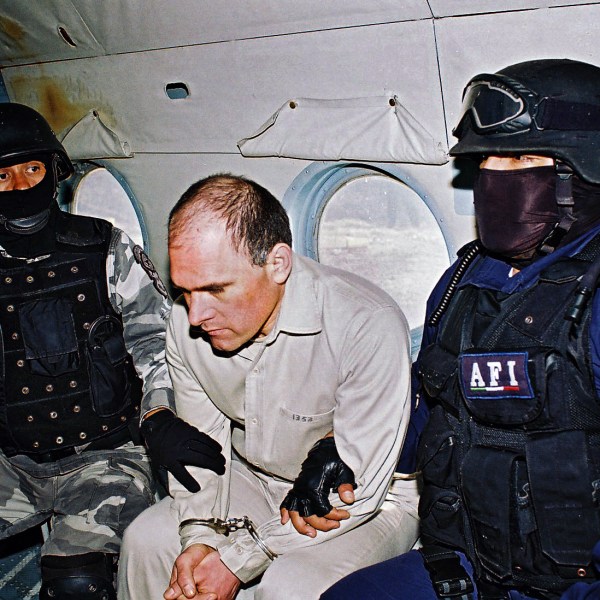 Head of the feared Gulf Cartel Osiel Cardenas Guillen is custodied in a plane by members of the Federal Agency of Investigations of Mexico, January 20, 2007.