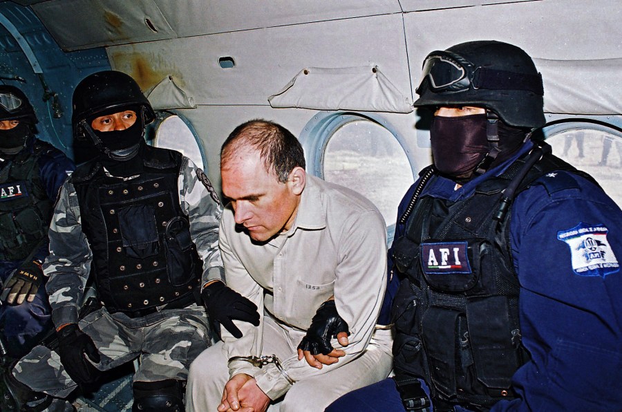 Head of the feared Gulf Cartel Osiel Cardenas Guillen is custodied in a plane by members of the Federal Agency of Investigations of Mexico, January 20, 2007.