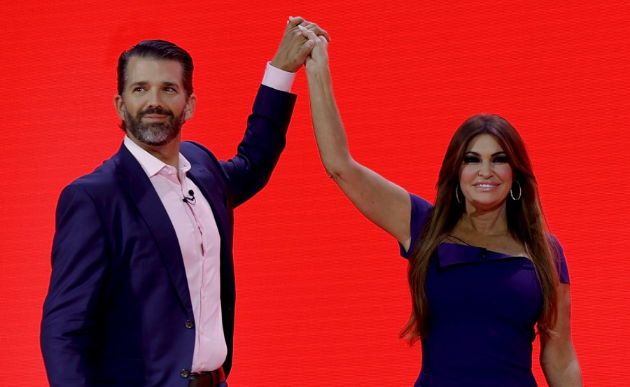 Donald Trump Jr. high-fives Kimberly Guilfoyle.