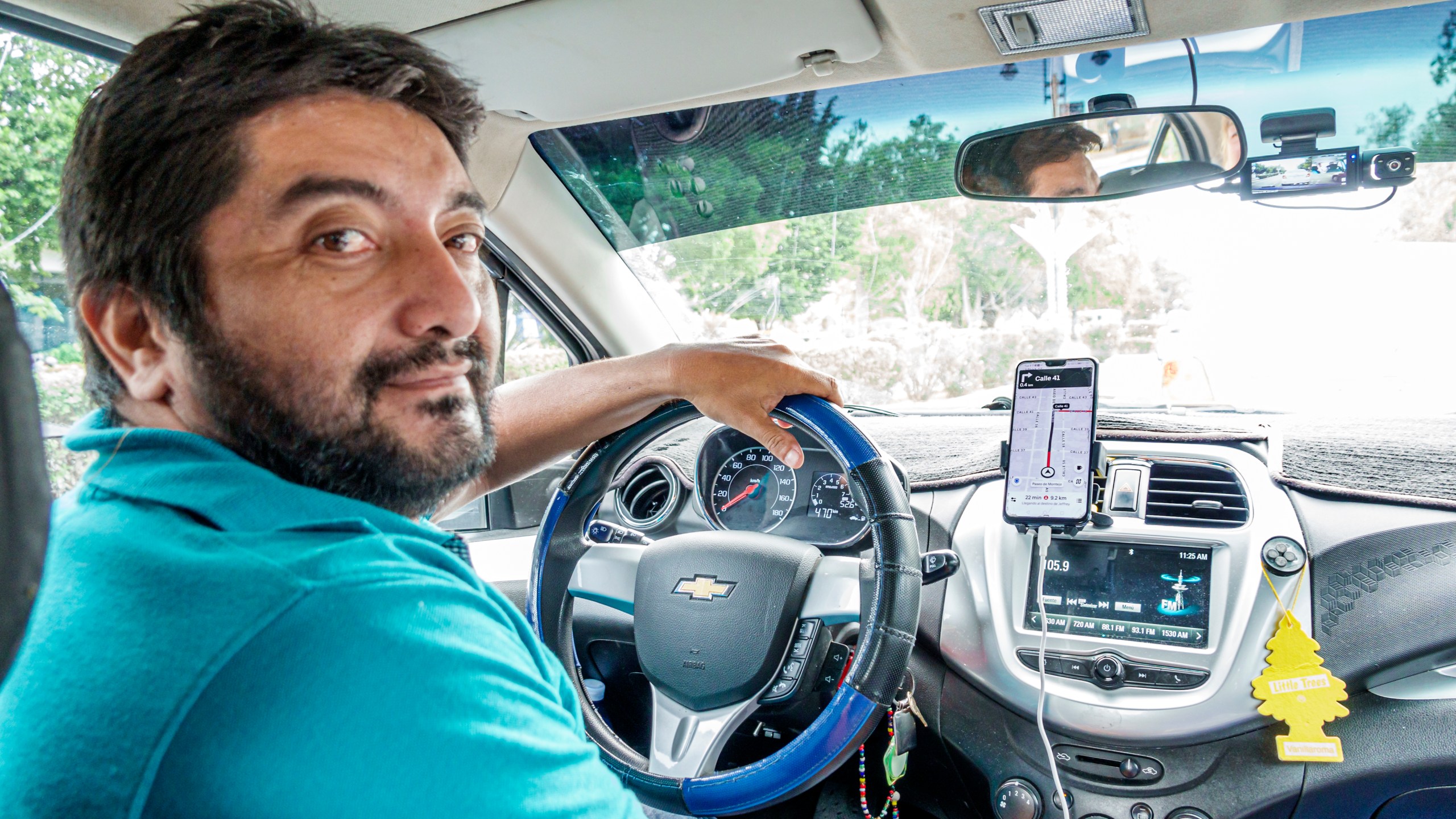 An Uber driver, as seen from the back seat of his car.