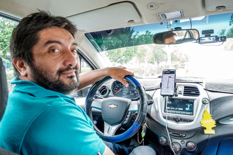 An Uber driver, as seen from the back seat of his car.