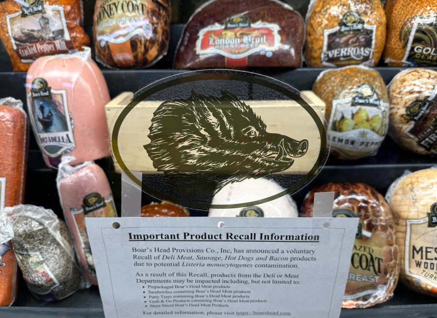 A deli counter display of various Boar's Head meats.