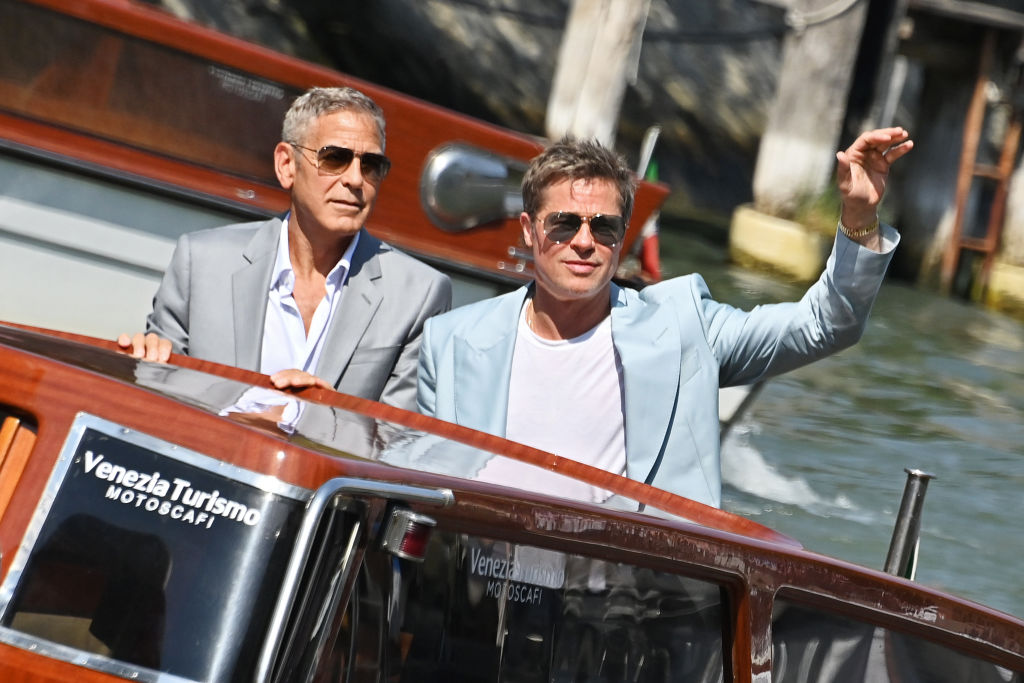 Brad Pitt and George Clooney arrive at a film festival.