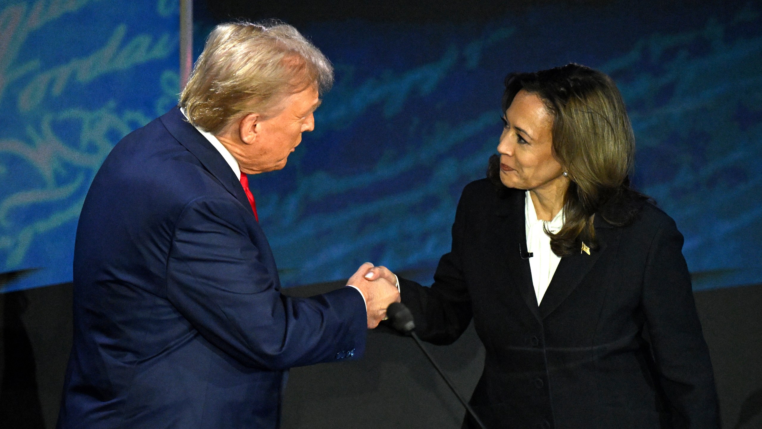 Democratic presidential candidate Kamala Harris (R) shakes hands with former US President and Republican presidential candidate Donald Trump during the presidential debate