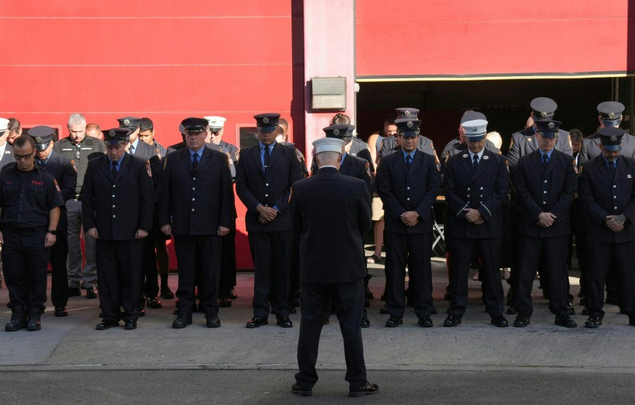 Firefighters pause for a second moment of silence outside FDNY Engine 4/Ladder 15's firehouse in lower Manhattan on the 23rd anniversary of the 9/11 terrorist attacks in 2001, on September 11, 2024 in New York.