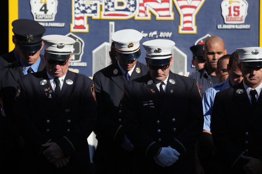 Firefighters pause for a second moment of silence outside FDNY Engine 4/Ladder 15's firehouse in lower Manhattan on the 23rd anniversary of the 9/11 terrorist attacks in 2001, on September 11, 2024 in New York.