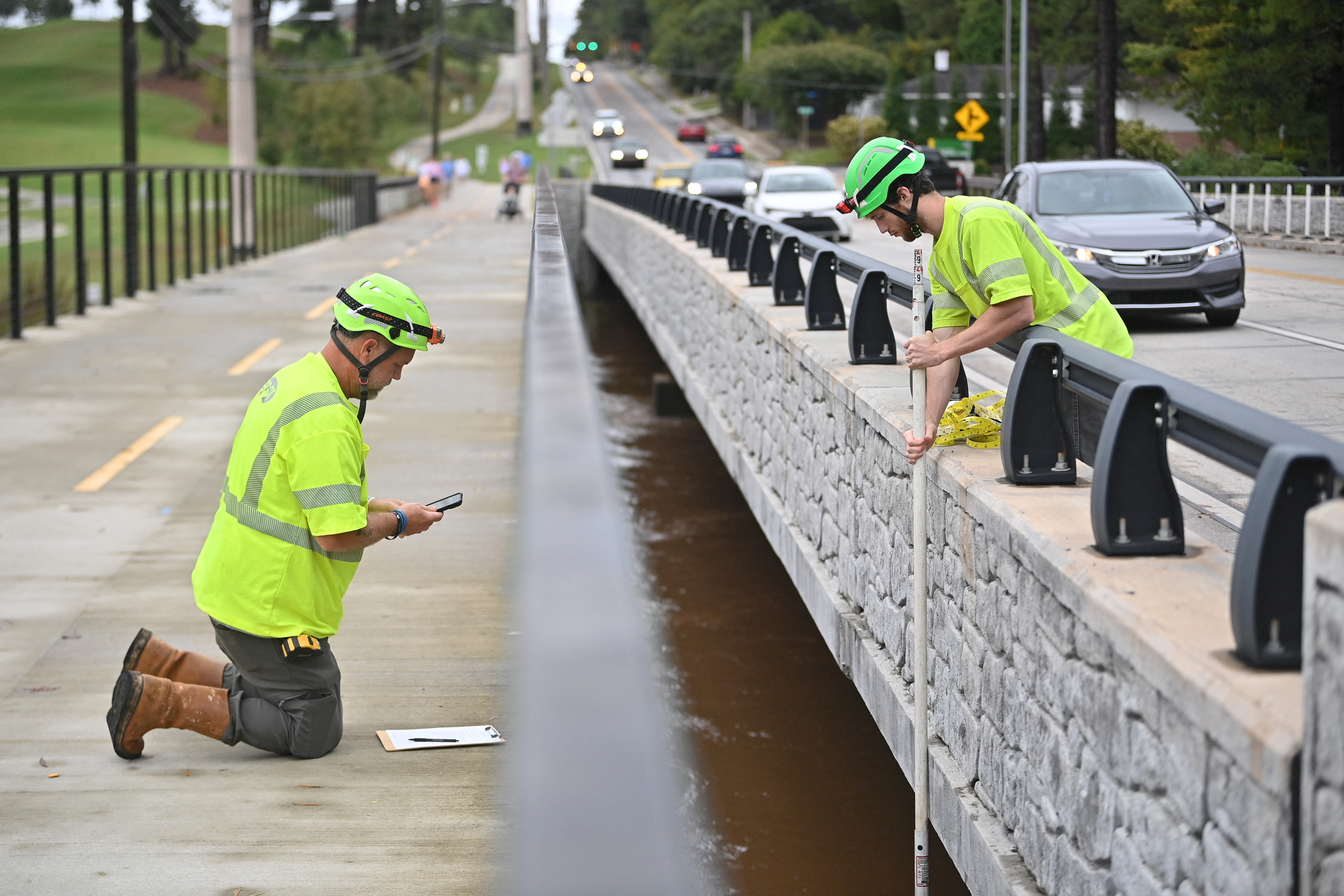 City workers measure the level of a river after Hurricane Helene made landfall in Atlanta, Georgia, on September 27, 2024.