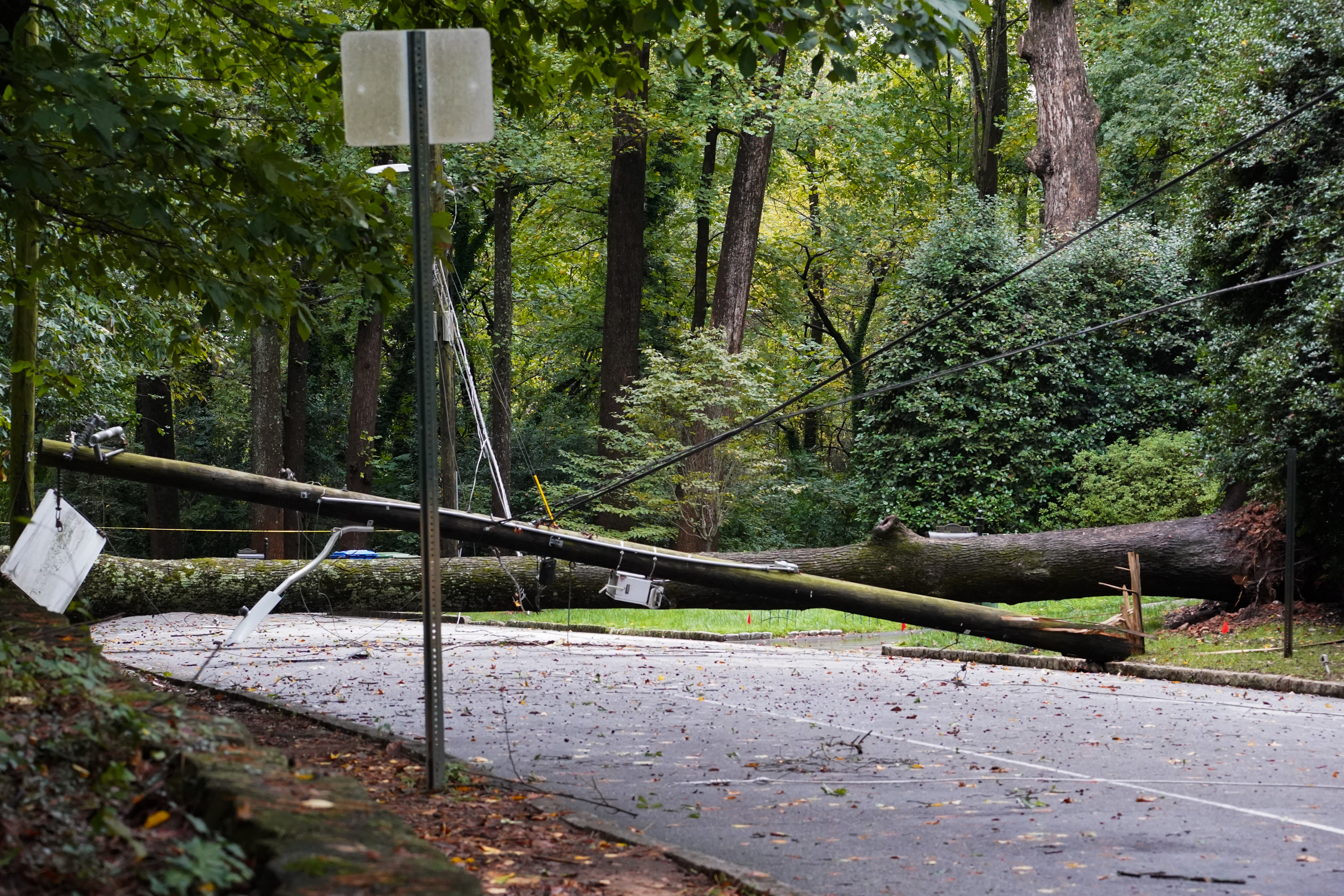 A tree and power line lay across a road in Buckhead after hurricane Helene brought in heavy rains overnight on September 27, 2024 in Atlanta, Georgia.