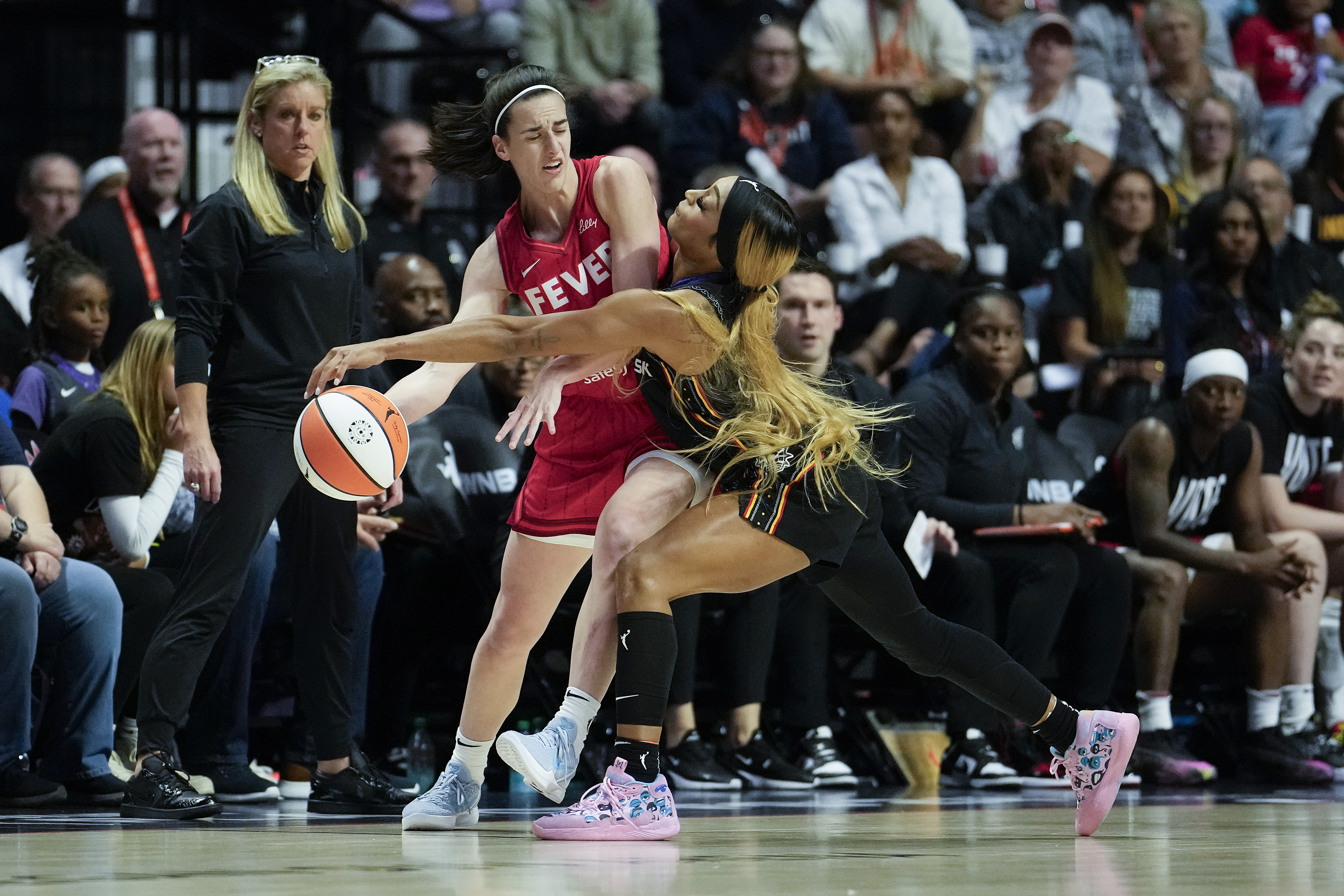 Caitlin Clark of the Indiana Fever looks to pass against DiJonai Carrington of the Connecticut Sun.