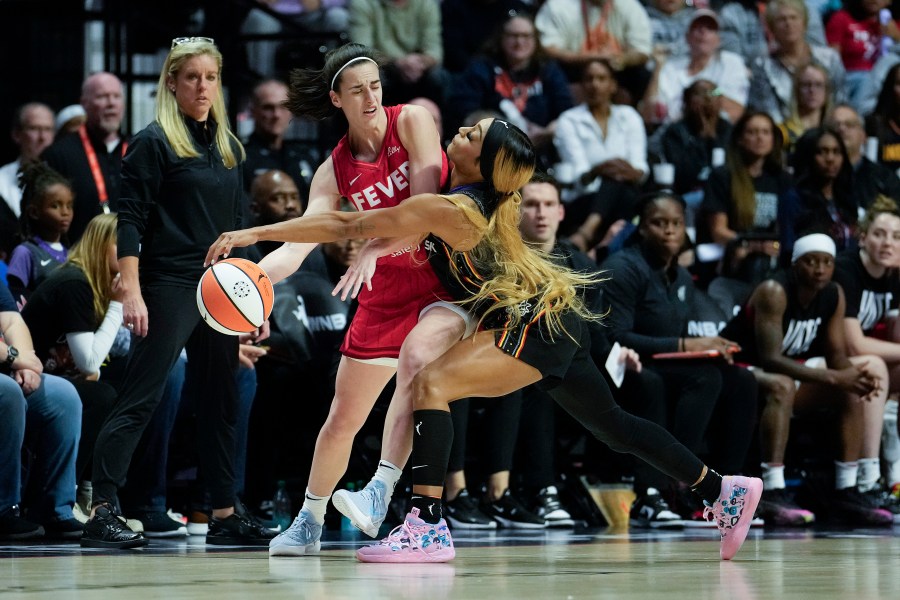 Caitlin Clark of the Indiana Fever looks to pass against DiJonai Carrington of the Connecticut Sun.