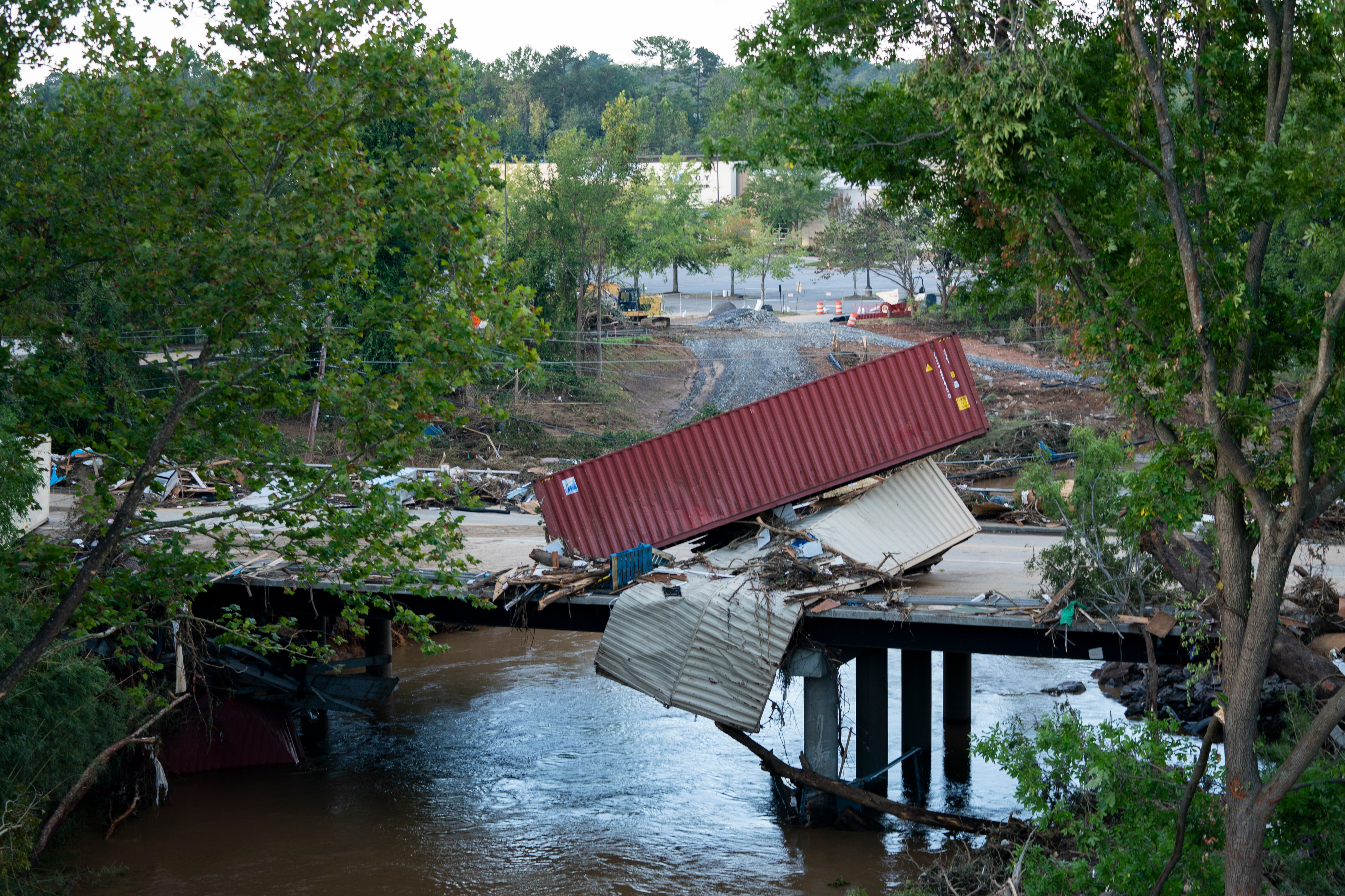 Flood damage is strewn across a road in the aftermath of Hurricane Helene on Sept. 29, 2024 in Asheville, North Carolina.