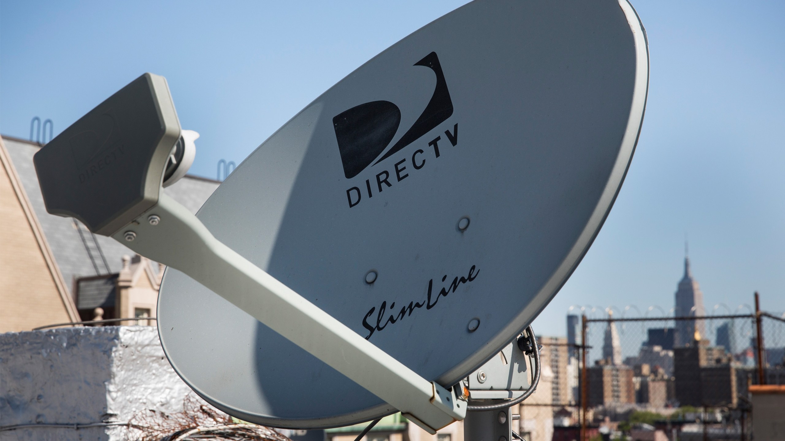 A DirecTV satellite dish sits on a roof in New York City.