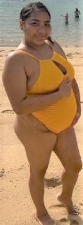 A pregnant woman in a bikini.