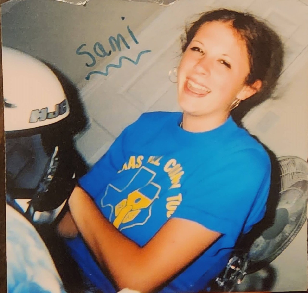 Samantha Tapp holding a motorcycle helmet.