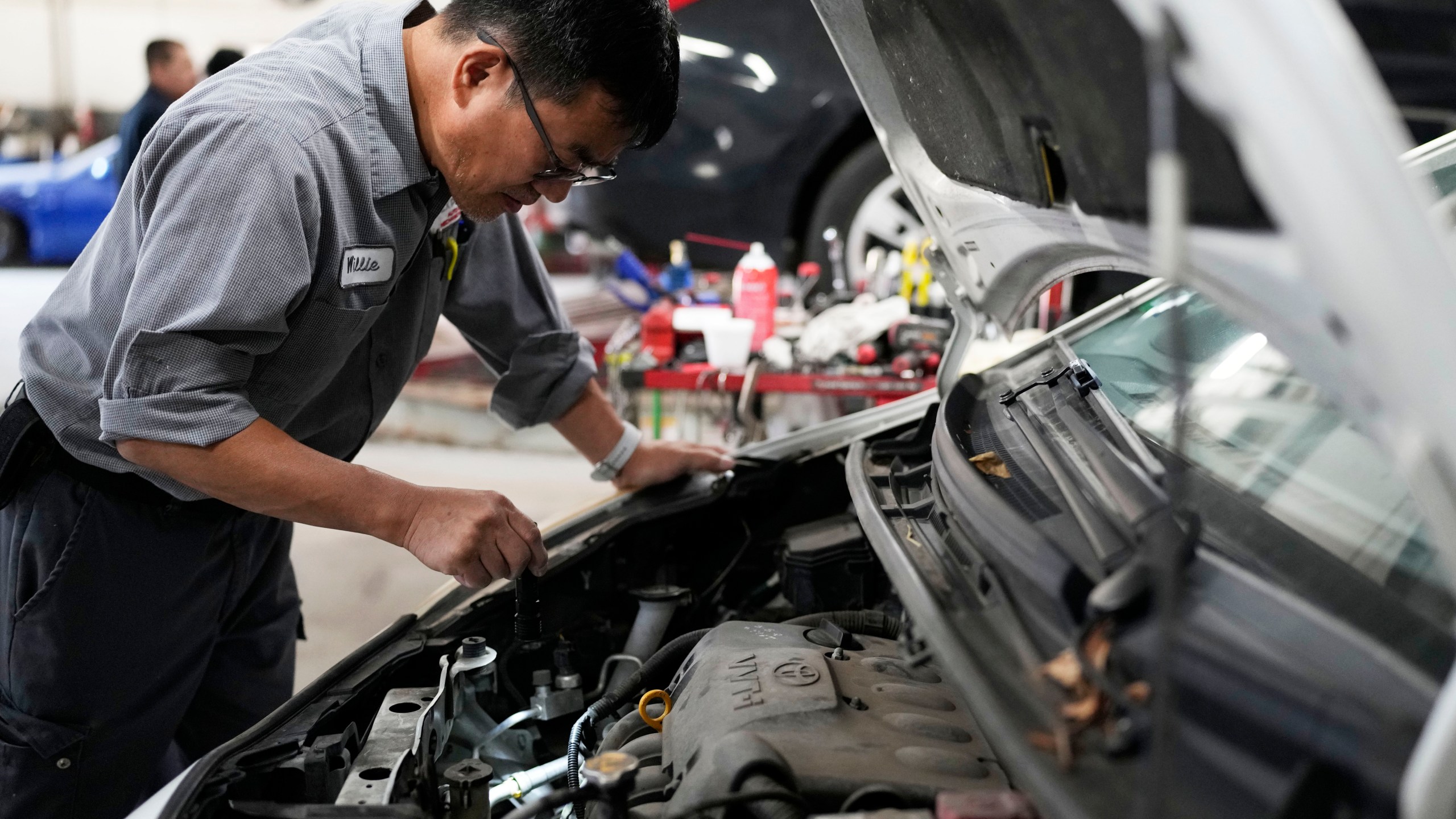 Auto mechanic Willie Chung works on a vehicle at the Express Auto Service Inc., in Chicago, Thursday, Sept. 19, 2024. (AP Photo/Nam Y. Huh)