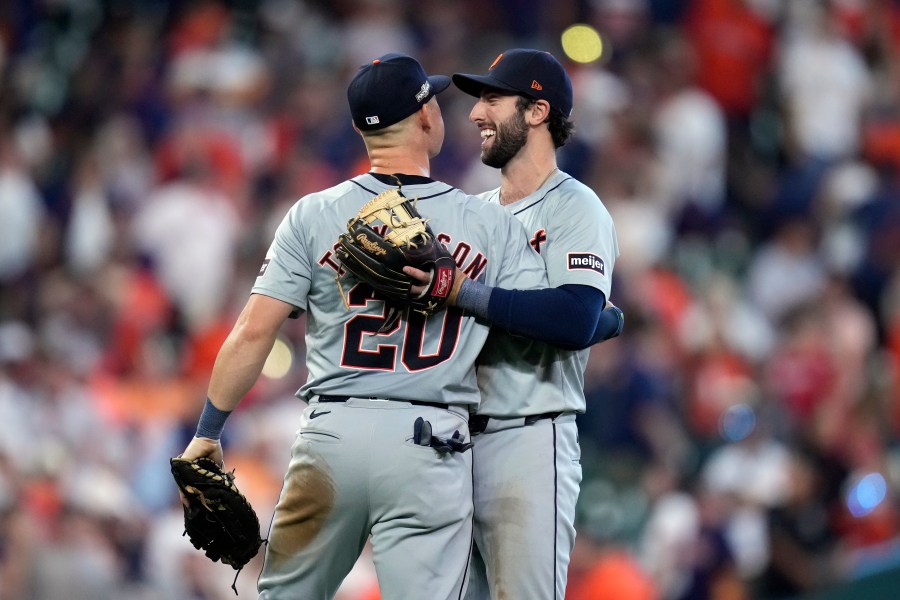 Detroit Tigers first baseman Spencer Torkelson (20) and third baseman Matt Vierling hug after the ninth inning of Game 1 of an AL Wild Card Series baseball game against the Houston Astros, Tuesday, Oct. 1, 2024, in Houston. (AP Photo/Kevin M. Cox)