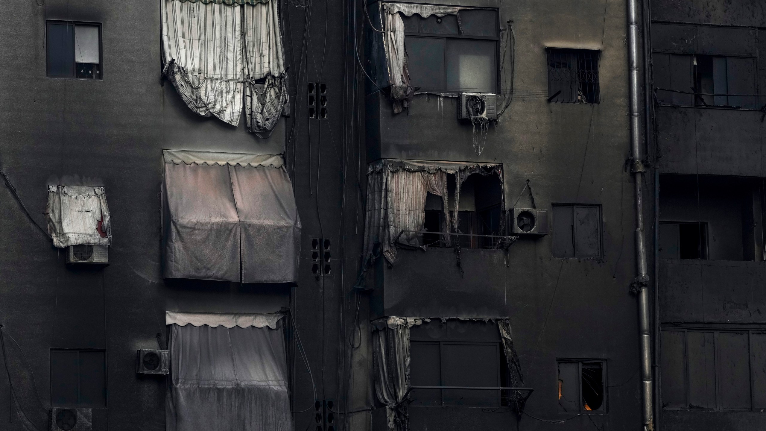 A burnt building shows damage at the site of an Israeli airstrike in Beirut's southern suburb, Lebanon, Tuesday, Oct. 1, 2024. (AP Photo/Hassan Ammar)