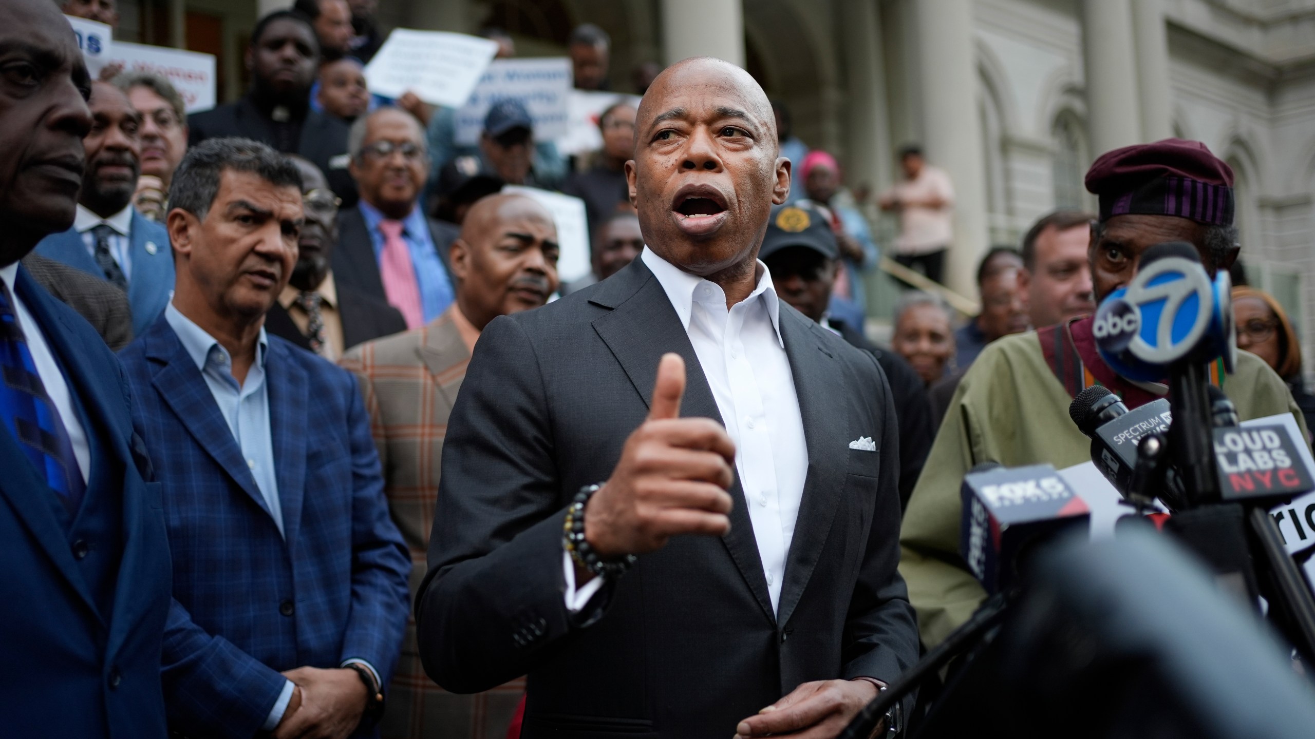 New York City Mayor Eric Adams speaks while surrounded by faith leaders and other supporters during a rally and prayer vigil on the steps of City Hall in New York, Tuesday, Oct. 1, 2024. (AP Photo/Seth Wenig)