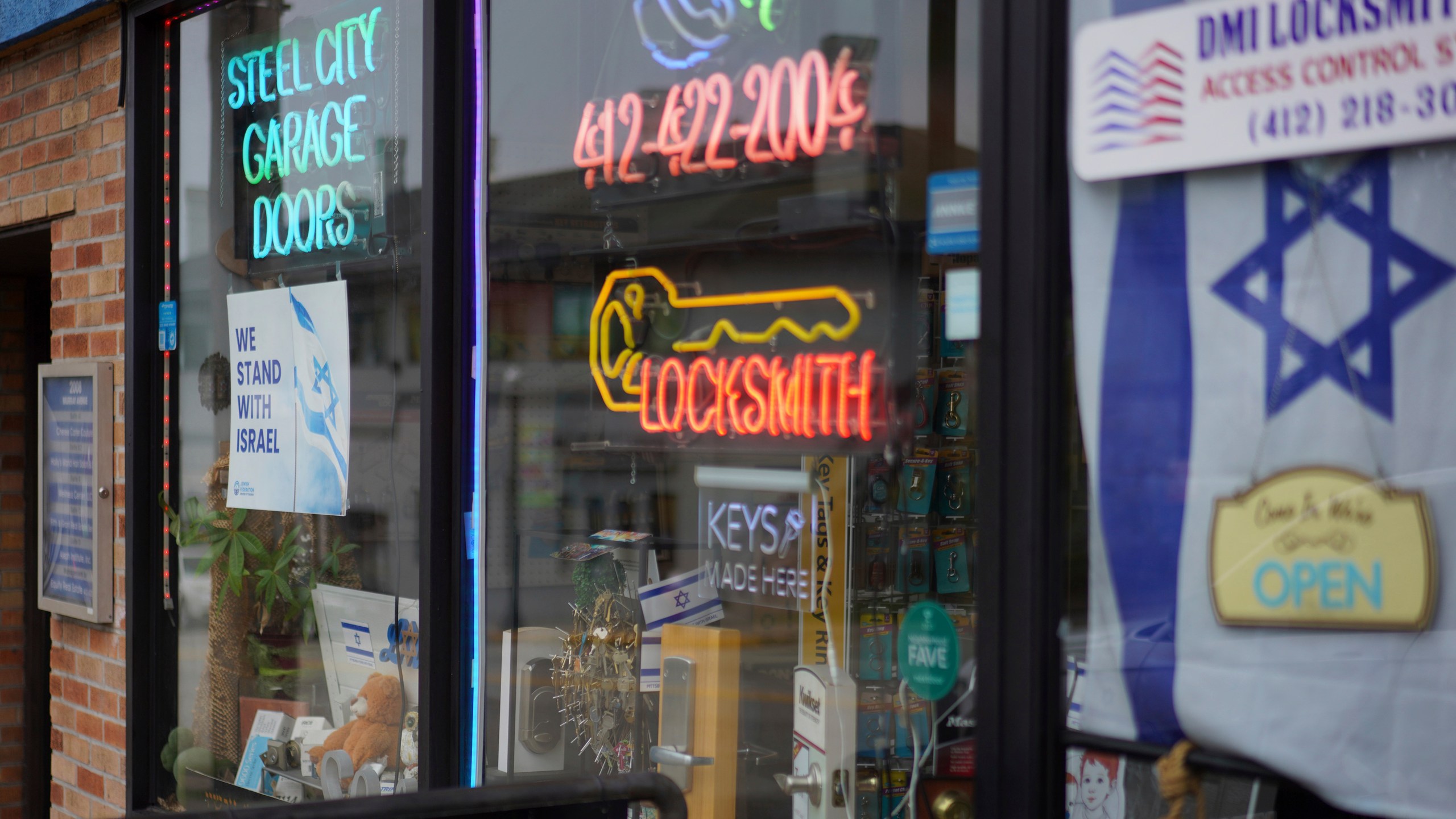 A local business in the Squirrel Hill neighborhood, the heart of Pittsburgh's Jewish community, displays an Israeli flag and signs in solidarity with Israel in its shop windows, Friday, Sept. 27, 2024, in Pittsburgh. (AP Photo/Jessie Wardarski)