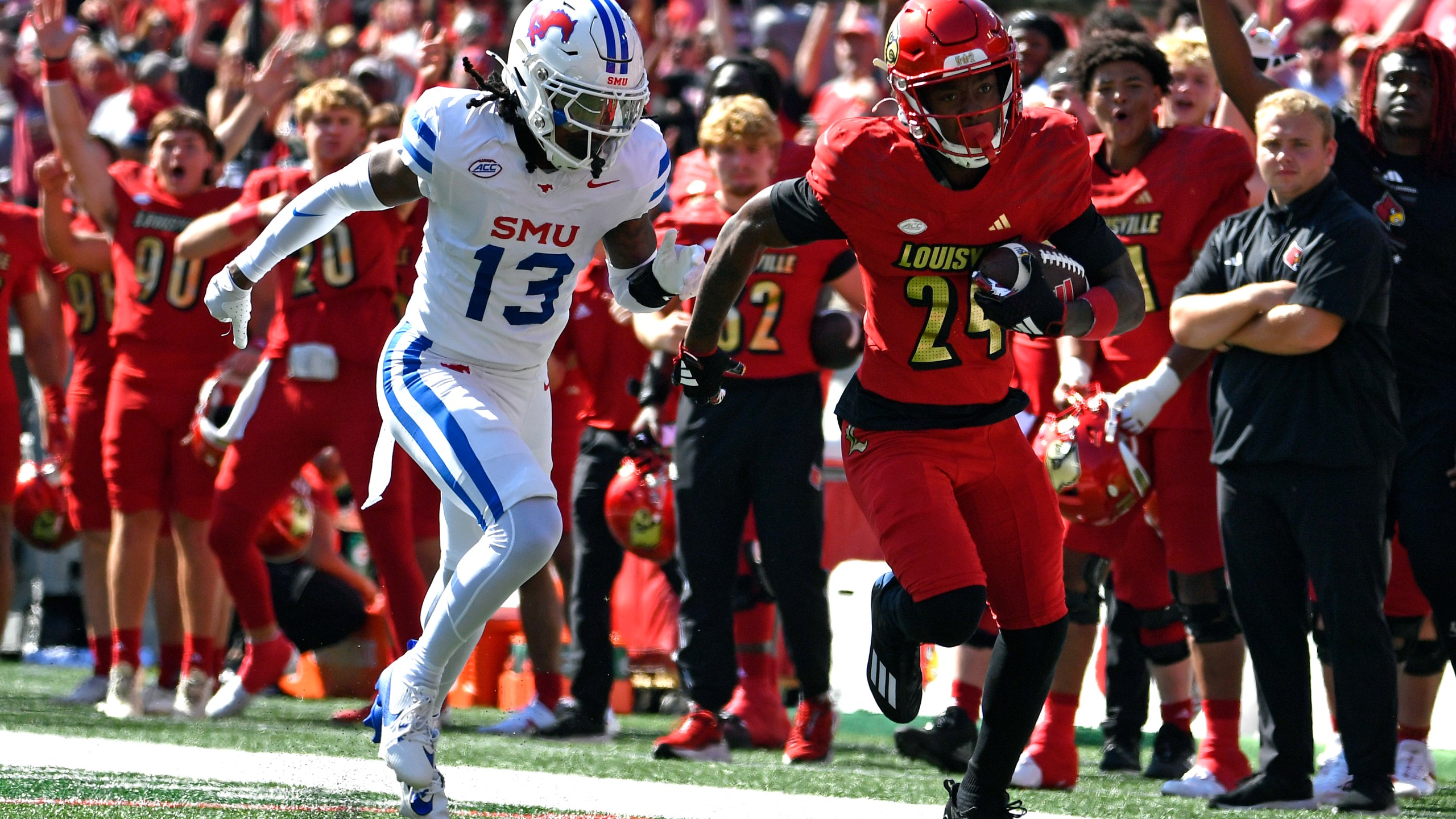 SMU cornerback Jaelyn Davis-Robinson (13) attempts to run down Louisville wide receiver Ahmari Huggins-Bruce (24) during the first half of an NCAA college football game in Louisville, Ky., Saturday, Oct. 5, 2024. (AP Photo/Timothy D. Easley)