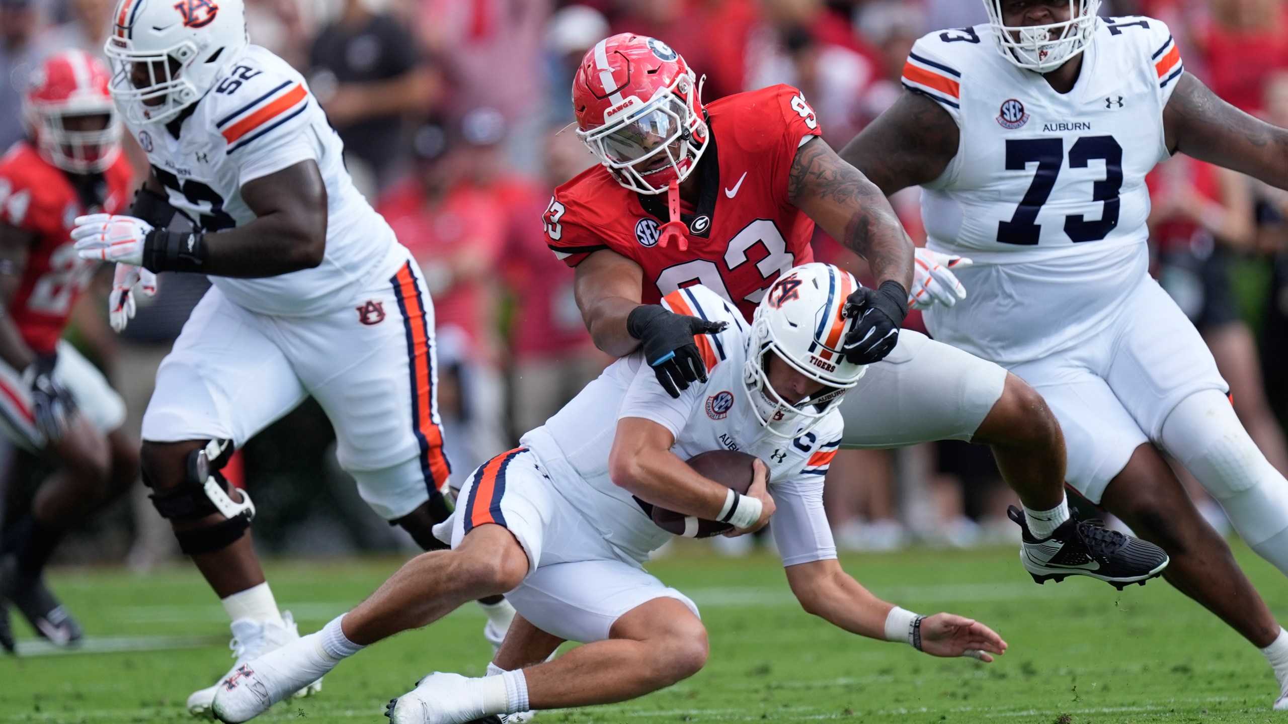 Auburn quarterback Payton Thorne (1) is sacked by Georgia defensive lineman Tyrion Ingram-Dawkins (93) in the first half of an NCAA college football game Saturday, Oct. 5, 2024, in Athens, Ga. (AP Photo/John Bazemore)