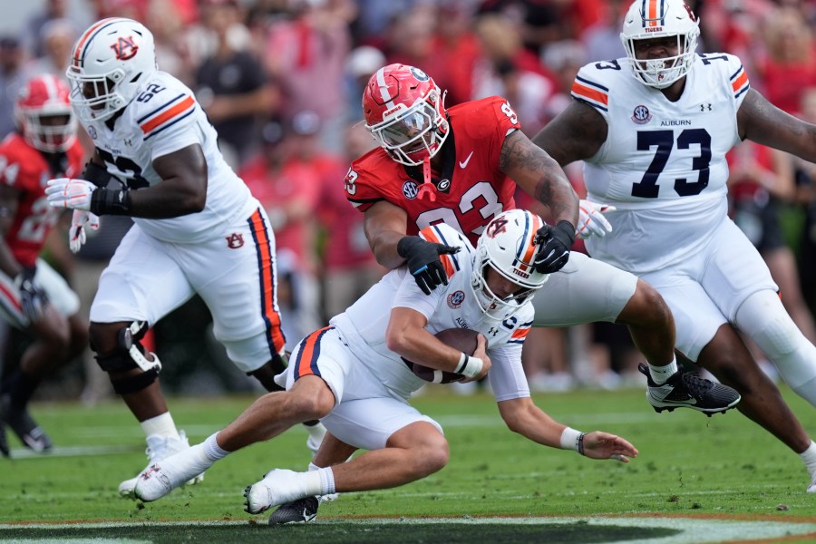 Auburn quarterback Payton Thorne (1) is sacked by Georgia defensive lineman Tyrion Ingram-Dawkins (93) in the first half of an NCAA college football game Saturday, Oct. 5, 2024, in Athens, Ga. (AP Photo/John Bazemore)