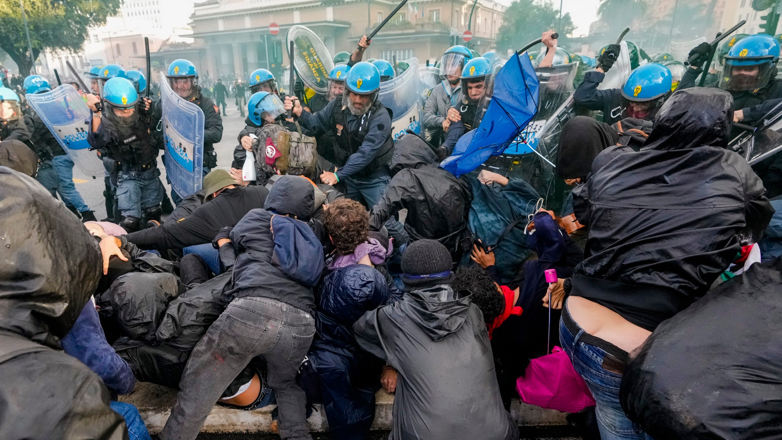 Italian Police and demonstrators clash during a march in support of the Palestinian people in Rome, Saturday, Oct. 5, 2024, two days before the anniversary of Hamas-led groups' attack in Israeli territory outside of Gaza on Oct. 7, 2023. (AP Photo/Andrew Medichini)