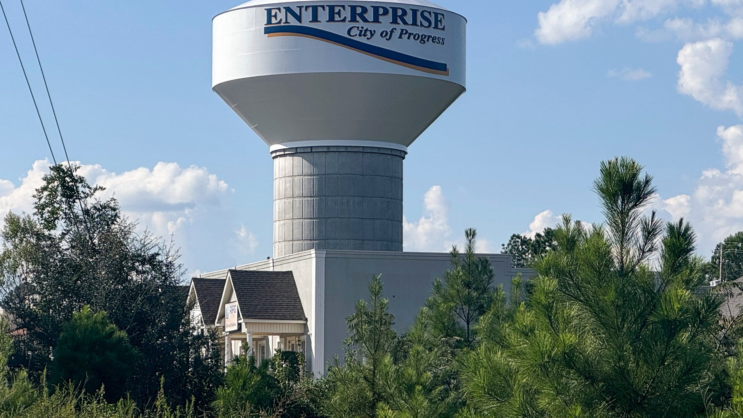 A water tower welcoming drivers into the town of Enterprise, Ala., with the words, "City of Progress," is seen, Sept. 19, 2024. (AP Photo/Safiyah Riddle)