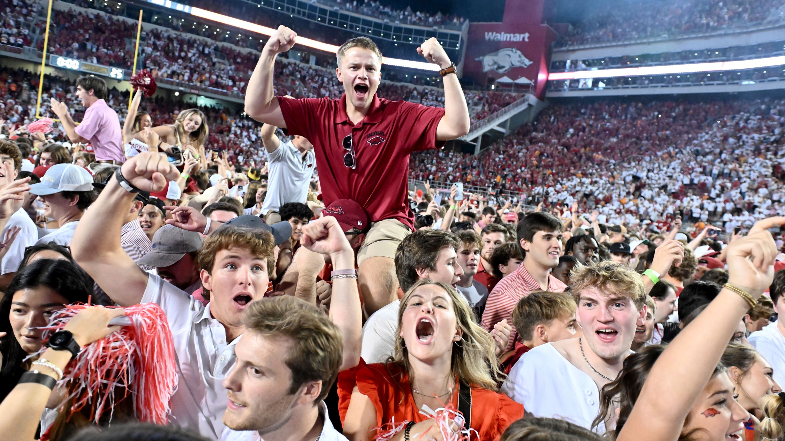 Arkansas fans celebrate after Arkansas upsets Tennessee 19-14 during an NCAA college football game, Saturday, Oct. 5, 2024, in Fayetteville, Ark. (AP Photo/Michael Woods)