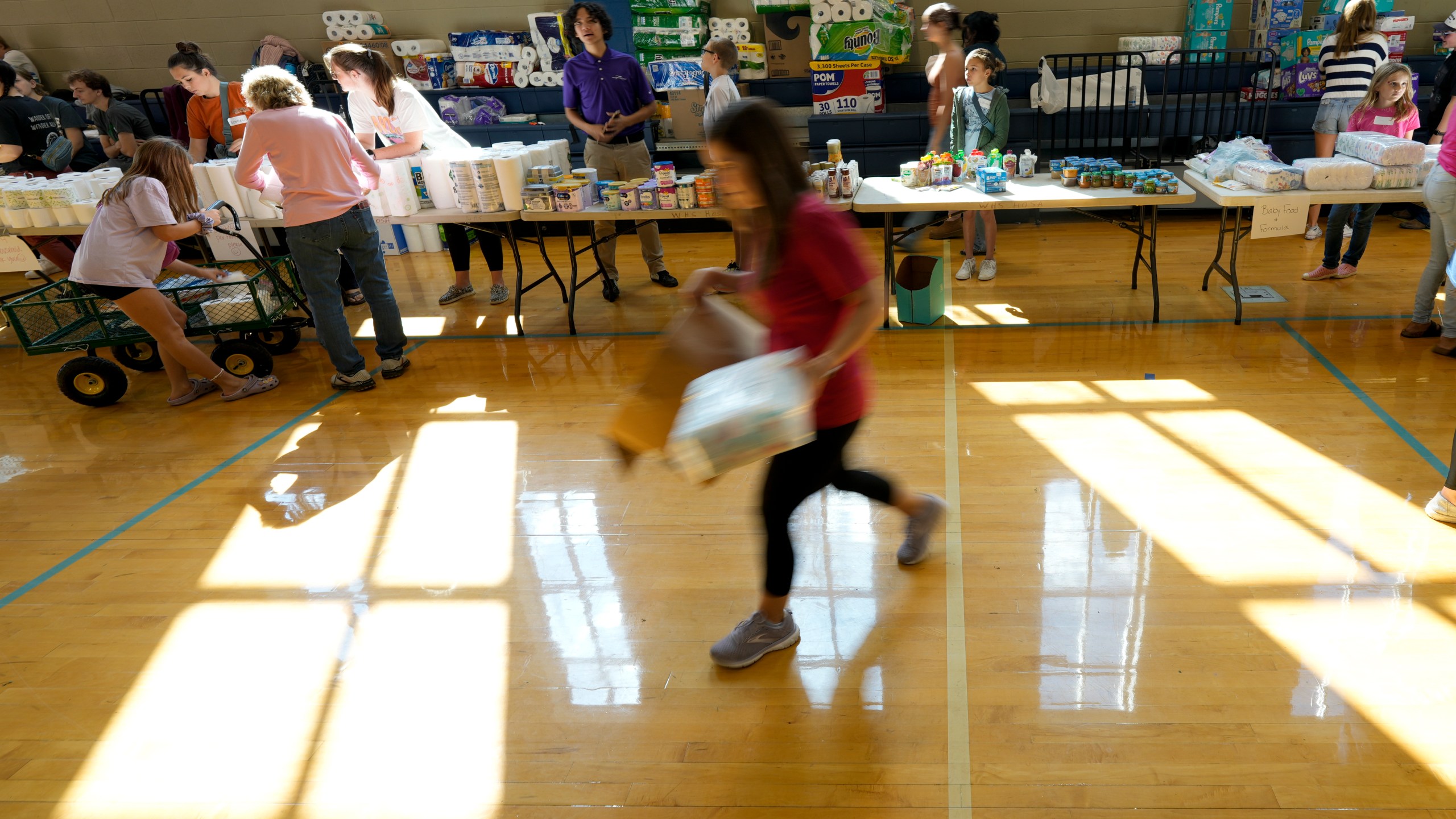 A volunteer unloads supplies at Watauga High School on Thursday, Oct. 3, 2024, in Boone, N.C. in the aftermath of hurricane Helene. In the final weeks of the presidential election, people in North Carolina and Georgia, influential swing states, are dealing with more immediate concerns: recovering from Hurricane Helene. (AP Photo/Chris Carlson)