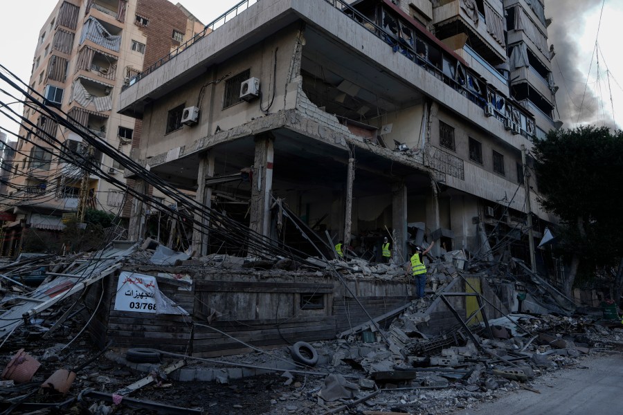 Emergency workers inspect a building that was hit in an Israeli airstrike in Dahiyeh, Beirut, Lebanon, Sunday, Oct. 6, 2024. (AP Photo/Bilal Hussein)