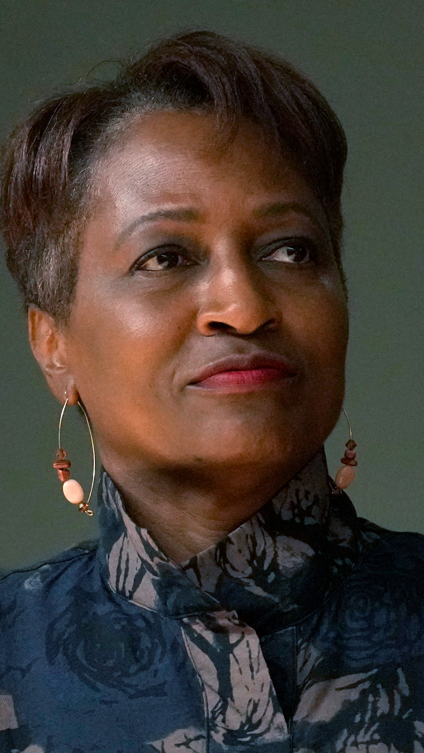 Mary Gardner, one of six nominees by Chicago Mayor Brandon Johnson to the Chicago Board of Education, listens to the mayor during a news conference introducing his nominees Monday, Oct. 7, 2024, in Chicago. (AP Photo/Charles Rex Arbogast)