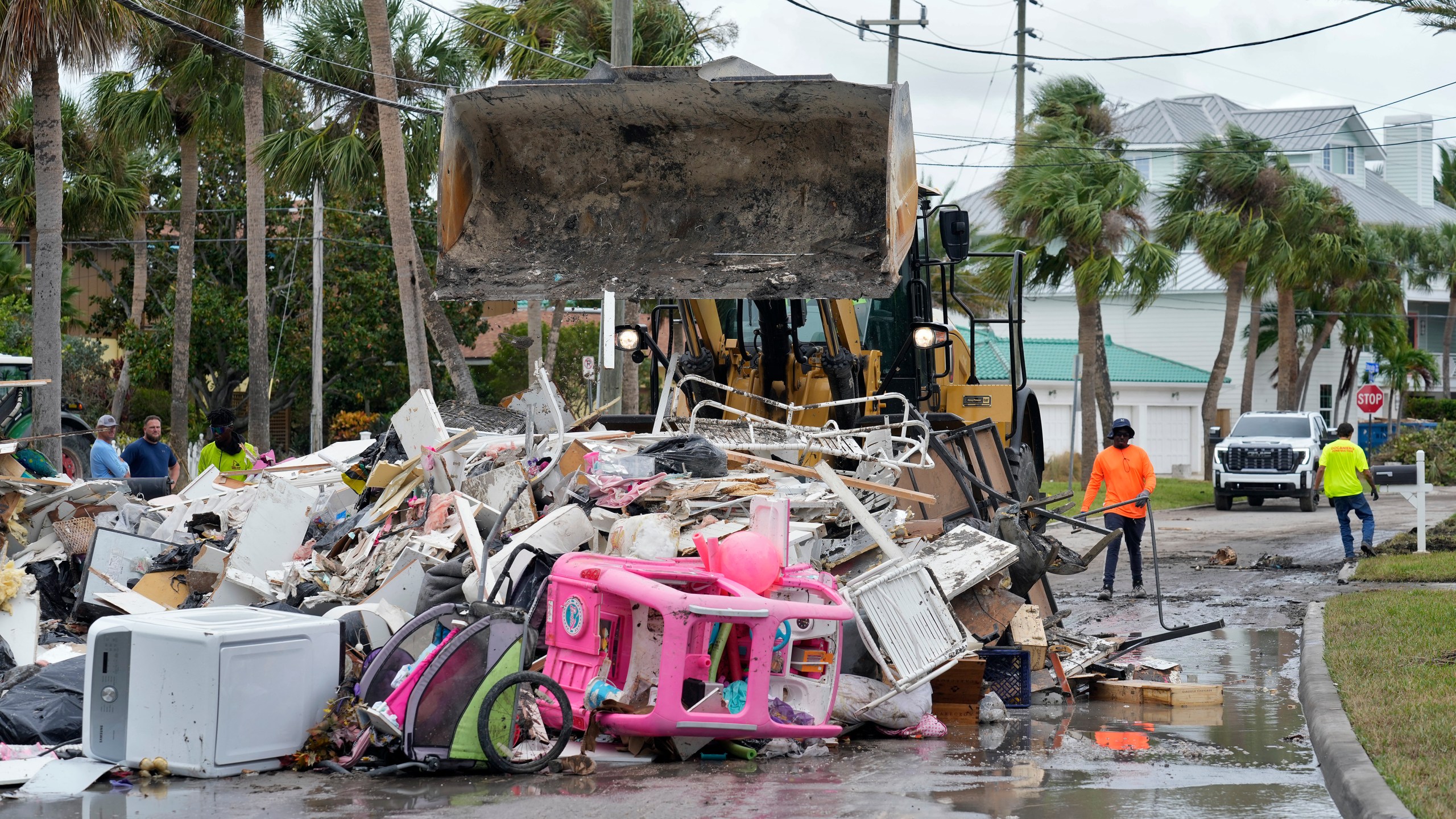 Salvage works remove debris from Hurricane Helene flooding along the Gulf of Mexico Monday, Oct. 7, 2024, in Clearwater Beach, Fla. Crews are working to remove the debris before Hurricane Milton approaches Florida's west coast. (AP Photo/Chris O'Meara)