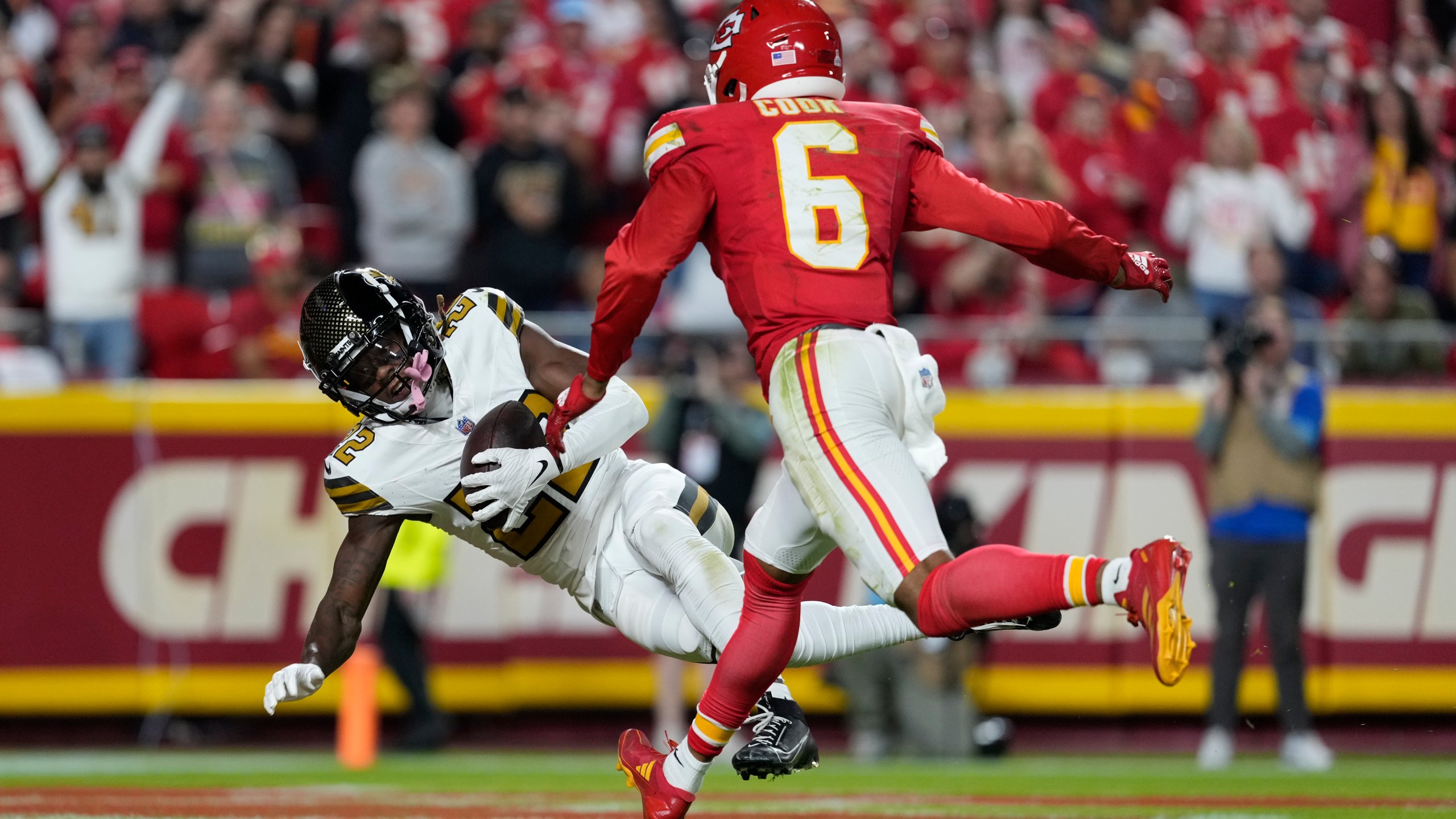 New Orleans Saints Rashid Shaheed, left, catches a touchdown pass as Kansas City Chiefs safety Bryan Cook (6) defends during the first half of an NFL football game Monday, Oct. 7, 2024, in Kansas City, Mo. (AP Photo/Ed Zurga)